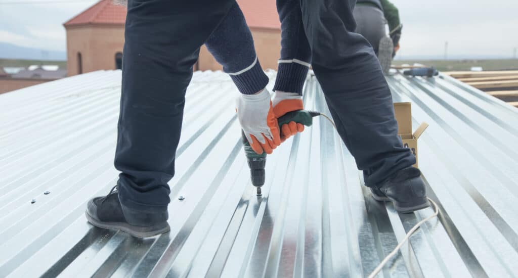 Man installing metal sheet roof